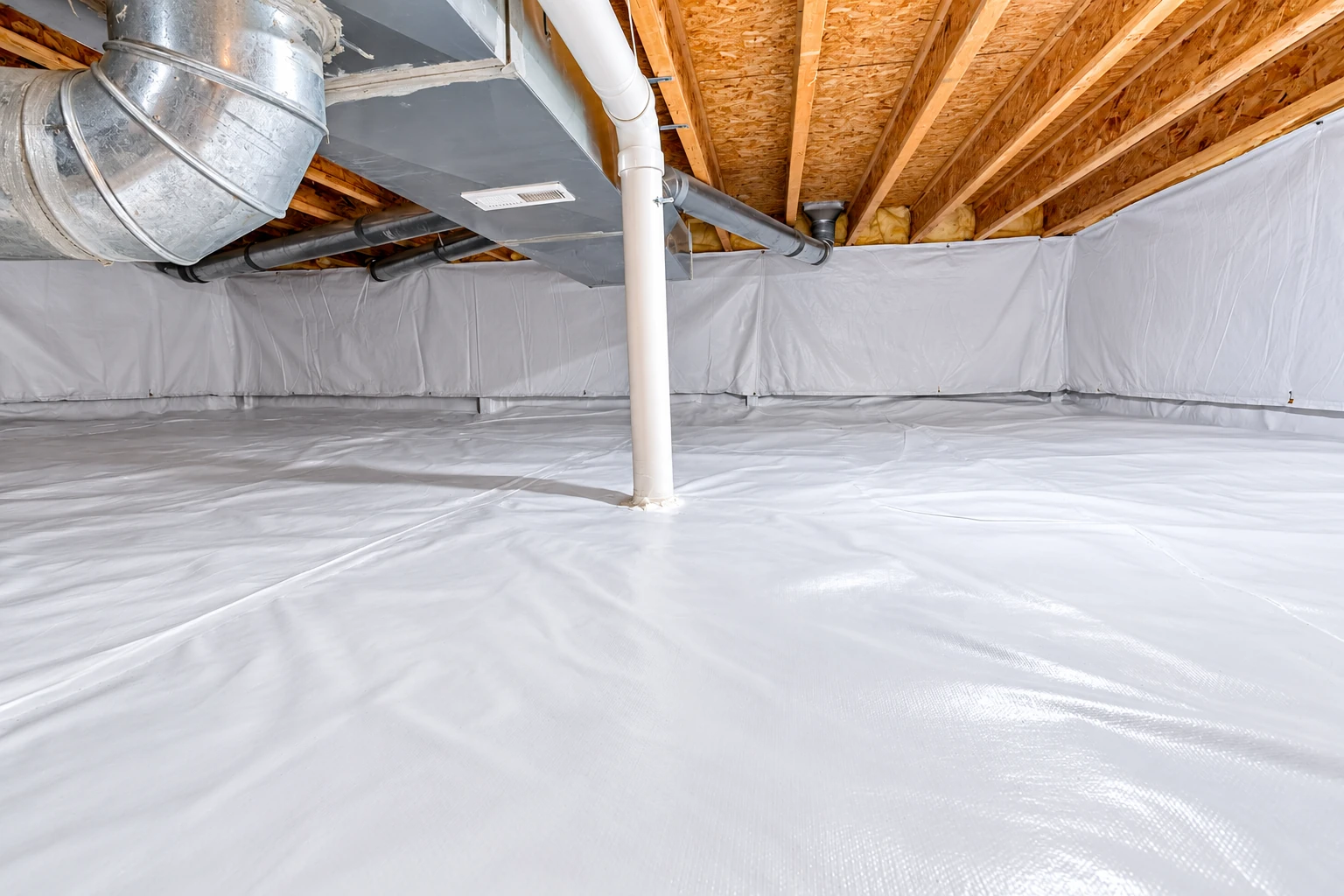 A crawl space has a white vapor barrier covering the floor and walls beneath exposed wooden joists and ductwork.