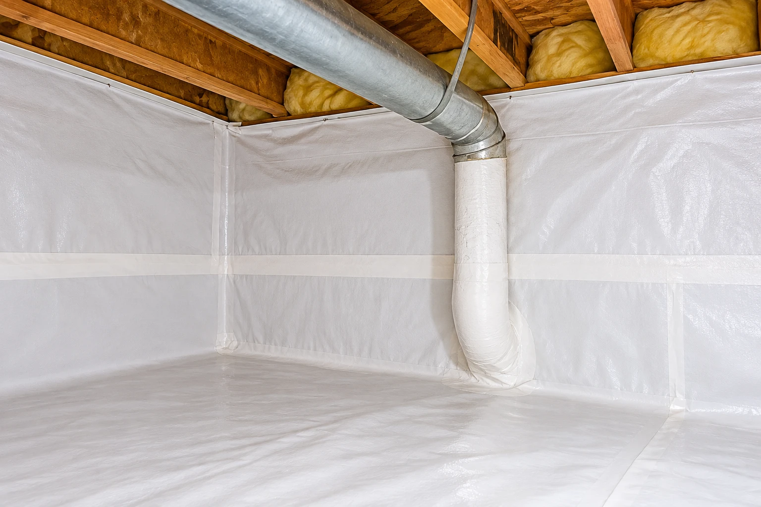 White vapor barrier sheeting covers a crawl space floor and walls around a duct.